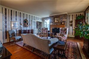 a living room with a couch and chairs and a fireplace at Oak & Anchor Inn in Penn Yan