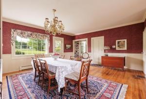 a dining room with a table and chairs at Oak & Anchor Inn in Penn Yan
