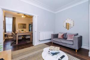a living room with a couch and a table at Monthly & Weekly Offers , Pool Table , PS4 , Liverpool , 3 Bed House , Ideal For Contractors , Relocation & Family Stays in Litherland +93 photos