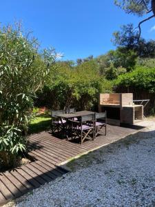 a picnic table and bench on a wooden deck at Mirando al Mar I in Mar Azul