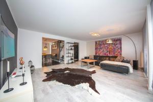 a living room with a couch and a table at Modern Luxury Villa Antonia in Mössingen