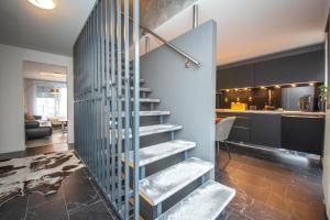a stair case in a room with a kitchen at Modern Luxury Villa Antonia in Mössingen