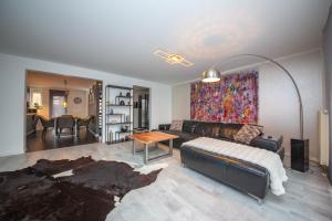 a living room with a couch and a table at Modern Luxury Villa Antonia in Mössingen