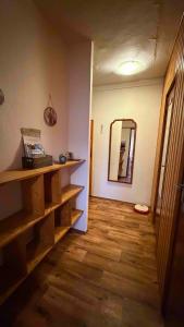 a room with a wooden floor and a mirror at U Aleny pod Radhoštěm in Rožnov pod Radhoštěm