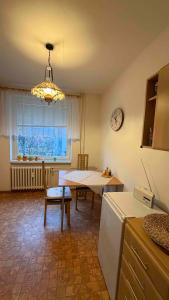a kitchen with a table and a clock on the wall at U Aleny pod Radhoštěm in Rožnov pod Radhoštěm
