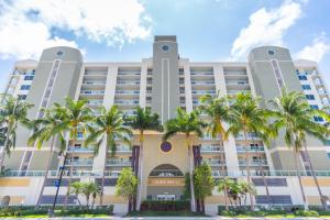 a building with palm trees in front of it at Golden Bay 808 in Miami Beach