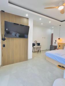 a bedroom with a large bed and a desk at TOKIO - Apartamentos by Luxury Atitlan in San Pedro La Laguna +25 photos