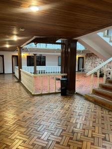 an empty room with a wooden floor and stairs at Hotel Santa Barbara in Arauca +1 photo