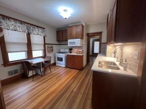 a kitchen with a sink and a table at Casa Lentini in Omaha