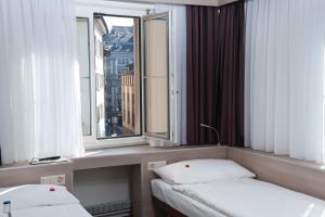 Posteľ alebo postele v izbe v ubytovaní Hotel Alexander Zurich Old Town