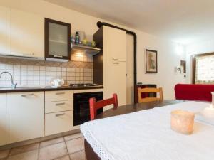 a kitchen and dining room with a table and a kitchen gmaxwell gmaxwell gmaxwell at Apartment Rote Rose by Interhome in Brusasco +23 photos