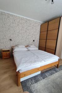 a bedroom with a bed with a wooden headboard at Apartment Ferienwohnung by Interhome in Tihany