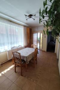a dining room with a table and chairs and windows at Apartment Ferienwohnung by Interhome in Tihany +21 photos