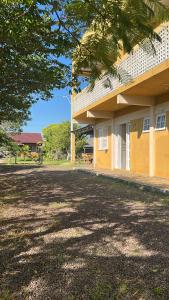 a building with a large yard in front of it at Pousada Mar & Sol in Torres