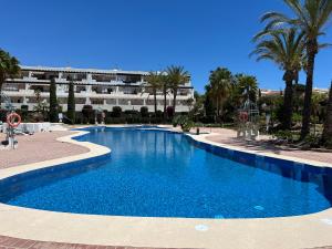 a large blue swimming pool in front of a building at Casa de Andres Mojácar in Mojácar