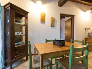 a dining room with a wooden table and chairs at Apartment Girasoli by Interhome in Brusasco