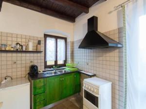 a kitchen with green cabinets and a sink at Apartment Girasoli by Interhome in Brusasco
