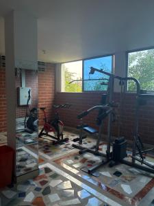 a gym with treadmills and exercise bikes in a room at Hotel Beijing Caucasia in Caucasia