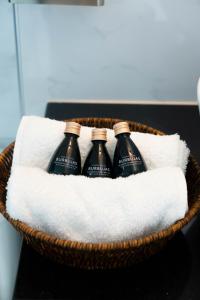 three bottles of wine in a basket on a towel at Solay Inn in Ayacucho