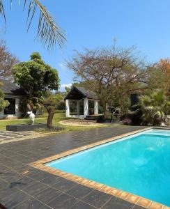 a swimming pool in front of a house at SPAat343 in Roodeplaat
