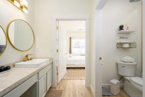 a white bathroom with a sink and a mirror at Casa Del Café in Bluffton +41 photos
