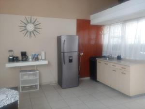 a kitchen with a stainless steel refrigerator in a room at Casa Altamirano in La Paz