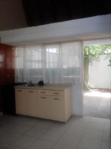 a kitchen with a sink and a large window at Casa Altamirano in La Paz