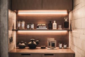 a wooden shelf with vases and bottles on it at The Slow in Canggu