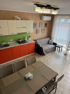 a kitchen and a living room with a table at Villa Vi-Ta in Zatoka