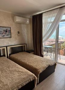 a bedroom with two beds and a view of a patio at Villa Vi-Ta in Zatoka +139 photos