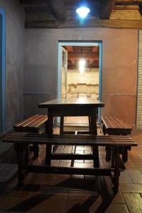 a picnic table in a room with two benches at Apartment Wohnung Leccio by Interhome in Castagneto Carducci