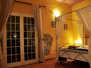 a bedroom with a bed and a door to a room at Apartment Wohnung Leccio by Interhome in Castagneto Carducci