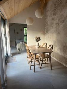 a dining room with a table and chairs and a bedroom at La Filature 1813 in Wasselonne