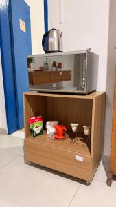 a microwave oven sitting on top of a wooden cabinet at Casa Colina in Ouro Preto