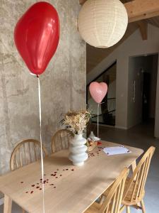 a table with a red balloon and a vase on it at La Filature 1813 in Wasselonne +13 photos