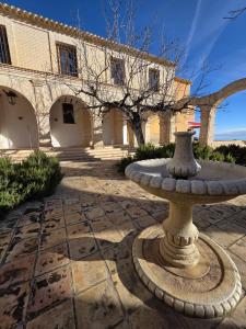 a stone fountain in front of a building at La Cilla Moratalla in Moratalla