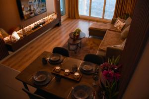 an aerial view of a living room with a dining table at Stellarlux Apartment, 35th floor in Skopje