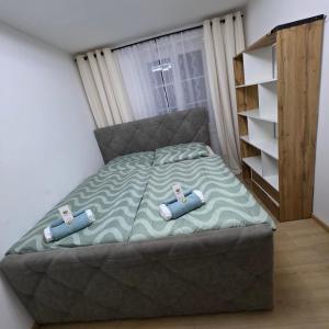a bed with two pillows on it in a bedroom at Apartment AlpenHerz Trieben in Trieben