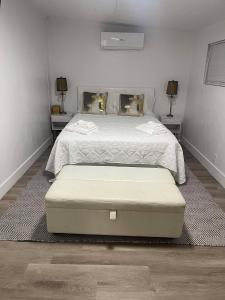 a bedroom with a large bed with two tables at Modern Hard Rock Apartment in Miramar