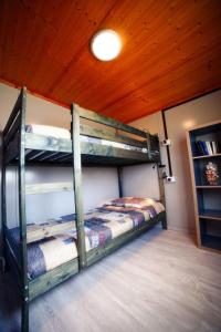 a bedroom with two bunk beds in a cabin at Apartment Haus Jasmin by Interhome in Castagneto Carducci