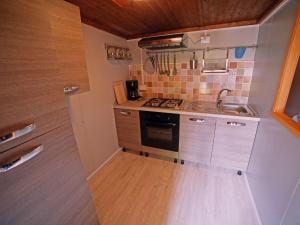 a small kitchen with a stove and a sink at Apartment Haus Jasmin by Interhome in Castagneto Carducci
