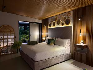 a bedroom with a large bed and a large window at La Font Ecolodge in Buenavista