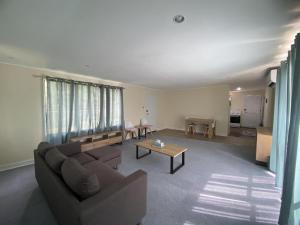 a living room with a couch and a table at Lagoon House in Veitongo