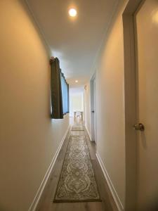 an empty hallway with a rug on the floor at Lagoon House in Veitongo +4 photos