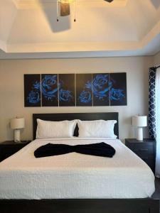 a bedroom with a large white bed with two lamps at Lake Lanier House 1 in Gainesville