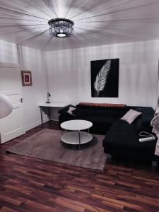 a living room with a couch and a table at Asken 8 in Klippan
