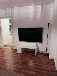 a living room with a flat screen tv on a wall at Asken 8 in Klippan +10 photos