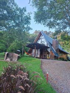 a house with a gambrel roof on the side of it at Chalet Relaggio in Encantado