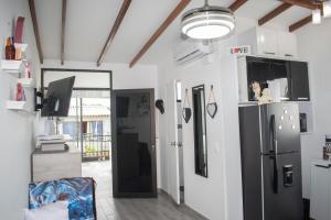 a kitchen with a black refrigerator and a door at Modern apartment/Studio in Pereira