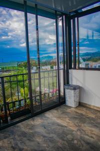 a balcony with glass doors and a view of the city at Modern apartment/Studio in Pereira